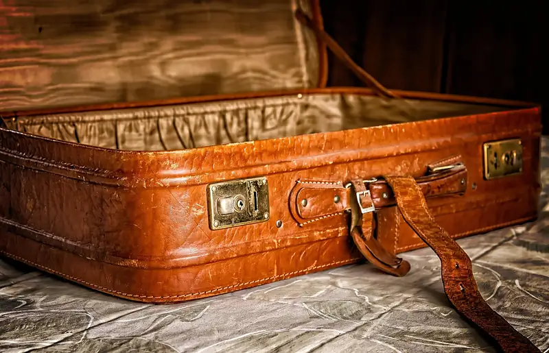 Open vintage leather suitcase ready for packing